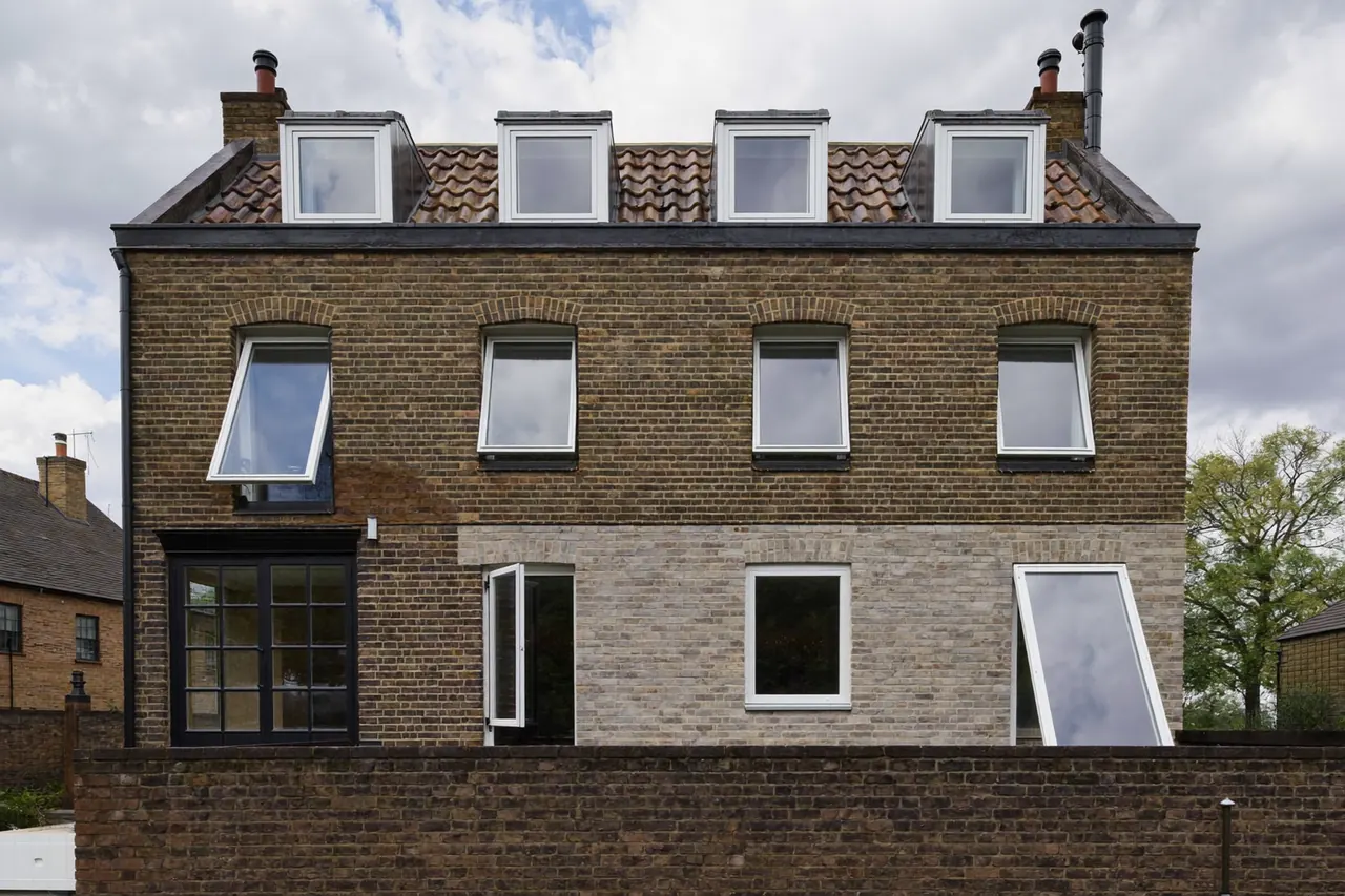 The front of a UK house with several replacement windows
